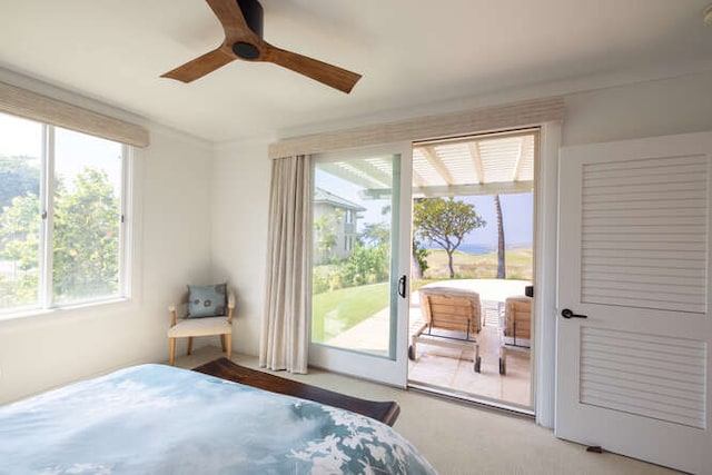 carpeted bedroom with access to exterior and a ceiling fan