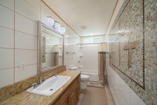 full bathroom with toilet, tile walls, vanity, shower / bath combination with curtain, and tile patterned flooring