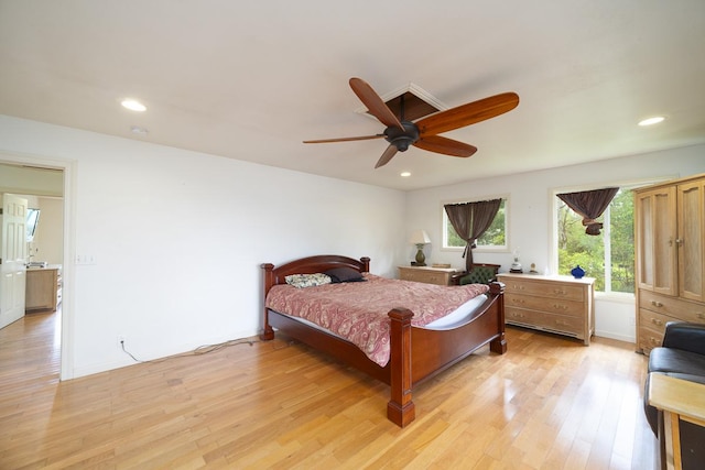 bedroom with light hardwood / wood-style flooring and ceiling fan