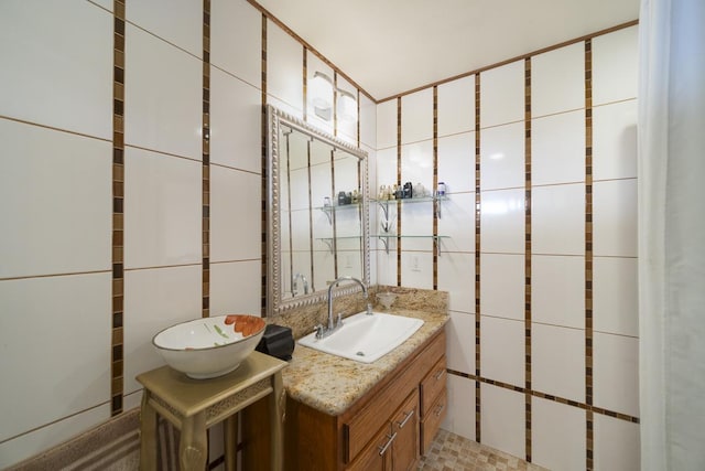 bathroom with tile walls and vanity