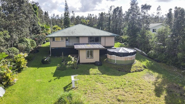 view of front facade featuring a pool and a front yard