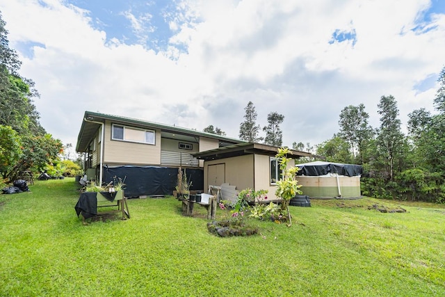 rear view of house with a yard