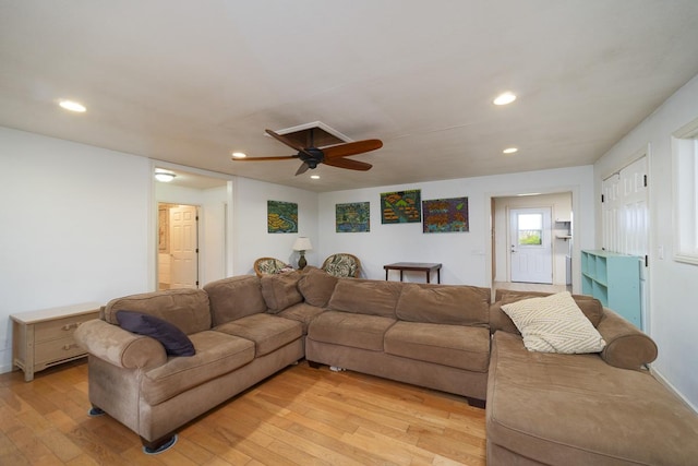 living room featuring ceiling fan and light hardwood / wood-style floors