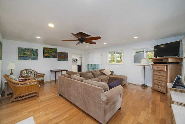 living room featuring ceiling fan and light hardwood / wood-style flooring