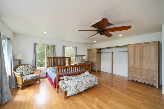 bedroom with ceiling fan, a closet, and light wood-type flooring