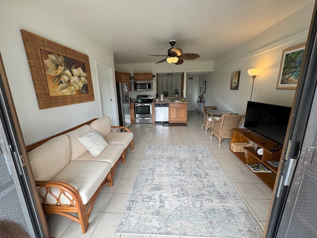 living room with ceiling fan and light tile patterned flooring