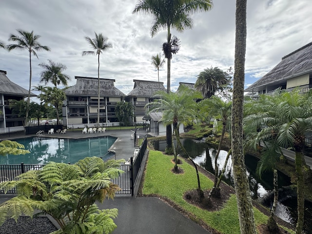 view of pool featuring a patio area and a water view