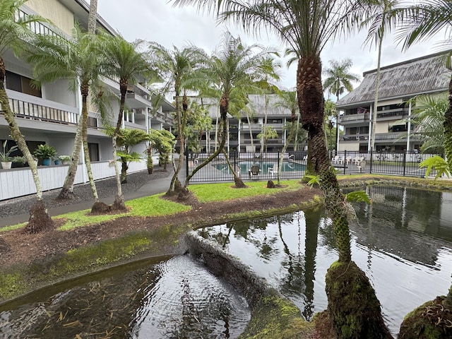 view of home's community with a water view and a pool