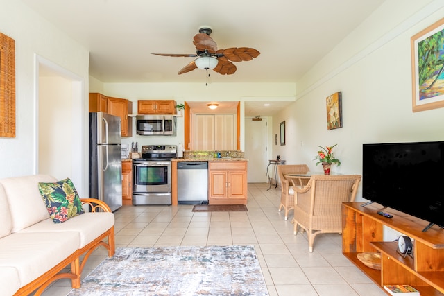 kitchen featuring light tile patterned flooring, ceiling fan, and stainless steel appliances