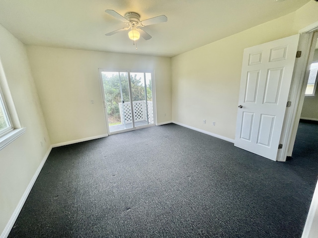 unfurnished room featuring ceiling fan and dark colored carpet