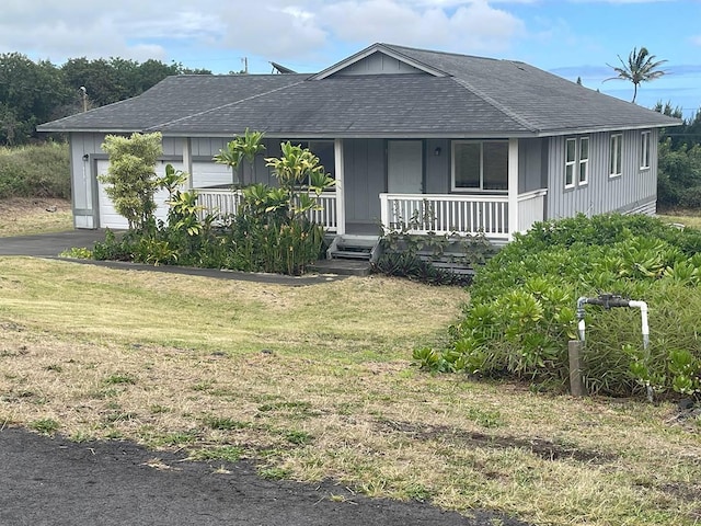 ranch-style house with a garage, a front lawn, and a porch