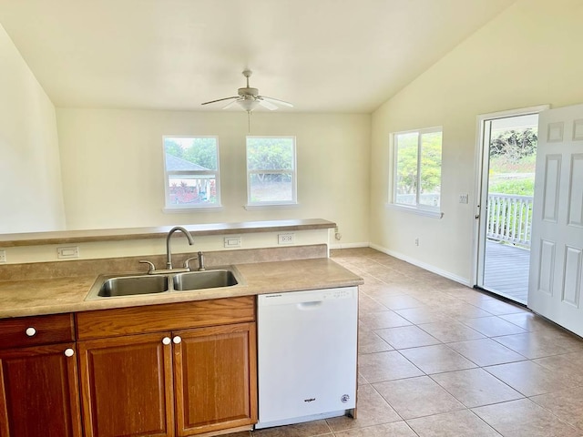 kitchen with sink, light tile patterned floors, dishwasher, ceiling fan, and vaulted ceiling