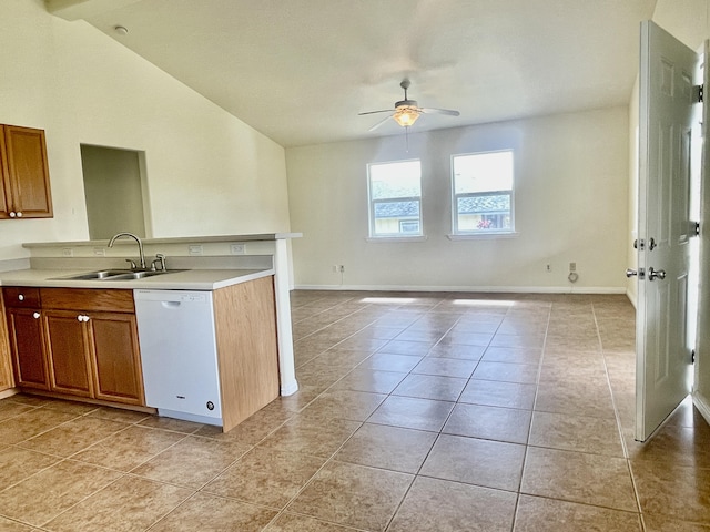 kitchen with vaulted ceiling, dishwasher, sink, light tile patterned floors, and ceiling fan