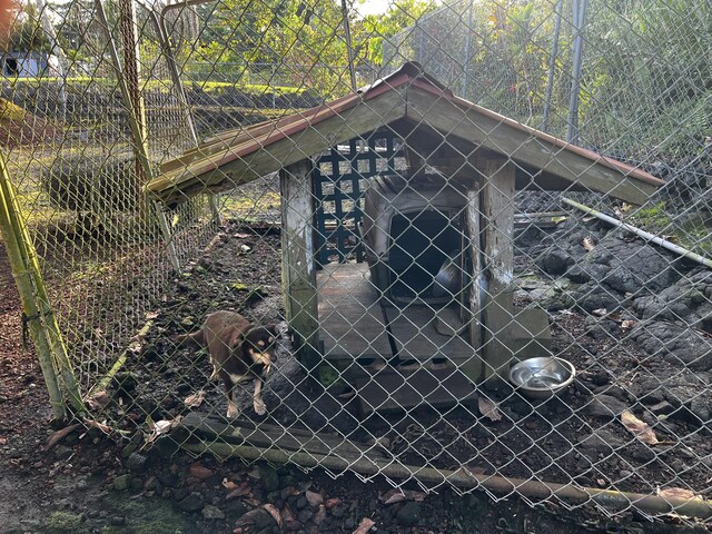 view of gate featuring an outbuilding