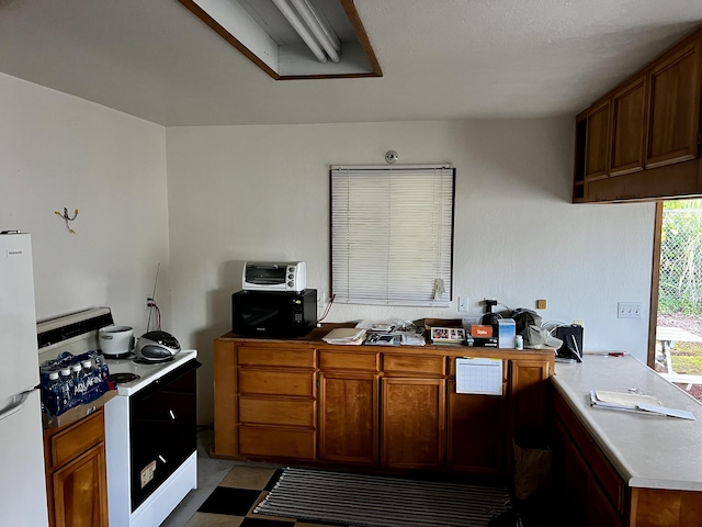 kitchen featuring white appliances and kitchen peninsula