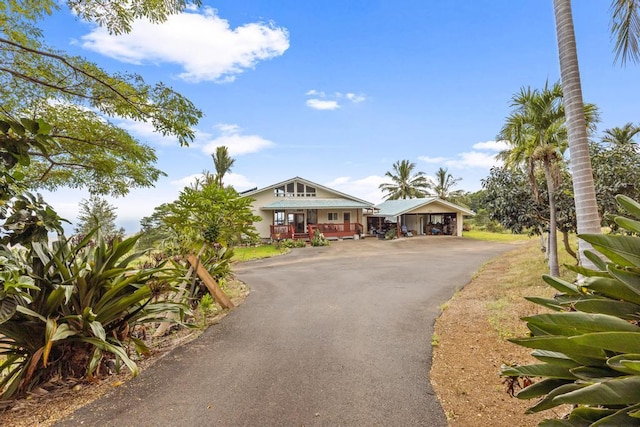 view of front of home with a porch and a carport