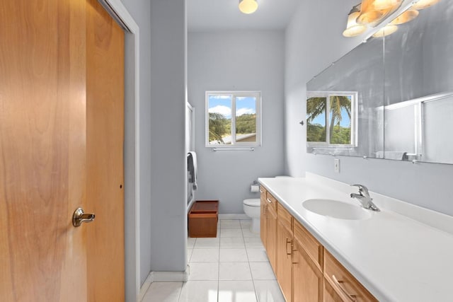 bathroom with vanity, a shower with shower door, tile patterned floors, and toilet