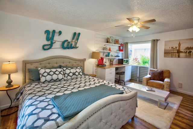 bedroom featuring hardwood / wood-style flooring, ceiling fan, and a textured ceiling