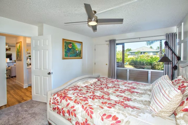 bedroom with ceiling fan and a textured ceiling