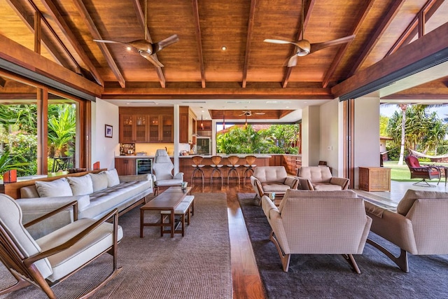 view of patio with a bar, wine cooler, outdoor lounge area, and ceiling fan