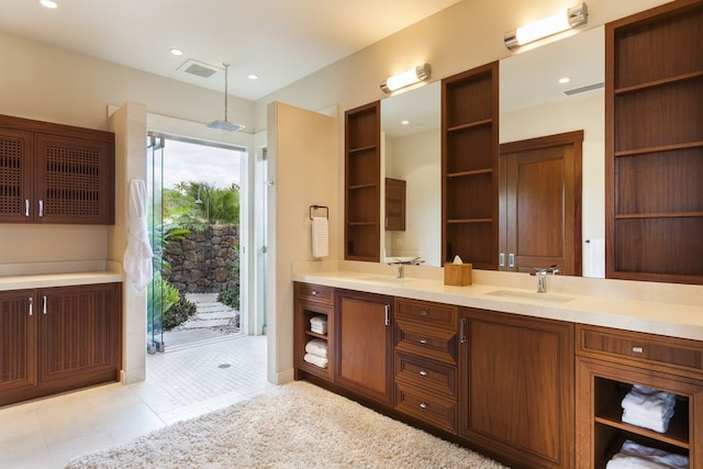 bathroom featuring vanity, tile patterned floors, and a shower