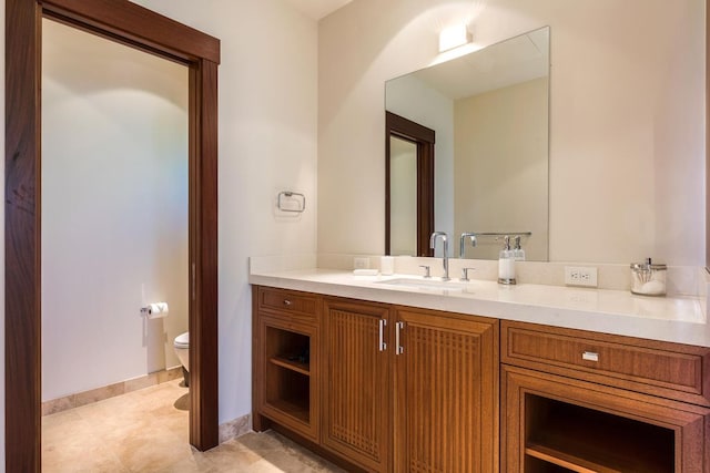 bathroom featuring vanity, tile patterned floors, and toilet