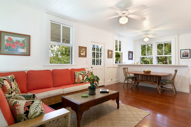 living room with ornamental molding and dark hardwood / wood-style flooring