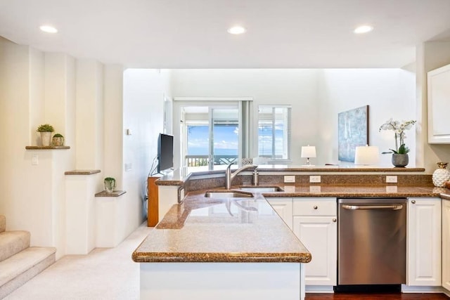 kitchen featuring stone counters, stainless steel dishwasher, sink, and white cabinets