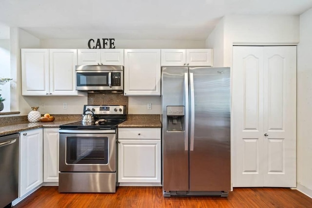 kitchen featuring white cabinetry, appliances with stainless steel finishes, and hardwood / wood-style floors