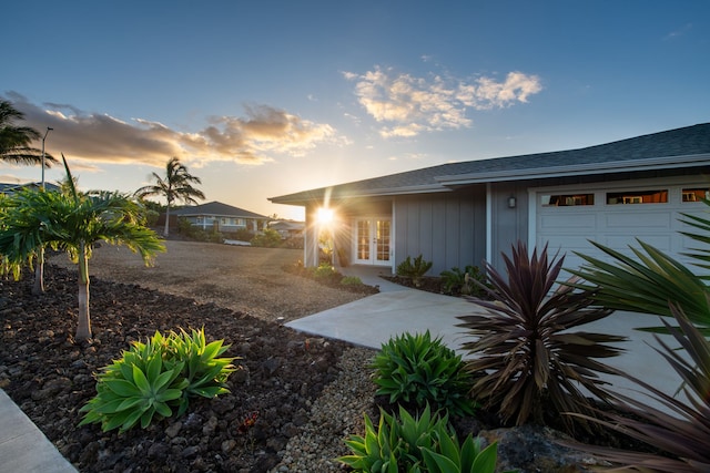 view of front of property featuring a garage and french doors