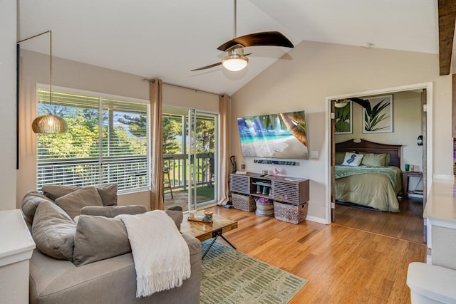 living room with hardwood / wood-style flooring, ceiling fan, and lofted ceiling