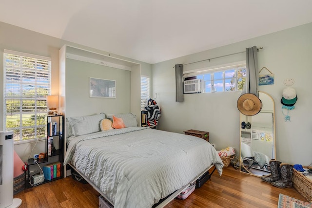 bedroom featuring dark hardwood / wood-style flooring and cooling unit