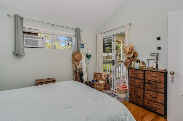 bedroom with lofted ceiling, cooling unit, access to exterior, and light hardwood / wood-style floors