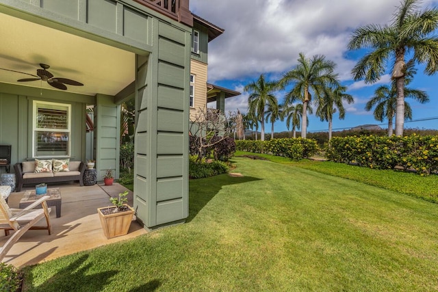 view of yard with an outdoor living space, a patio, and ceiling fan