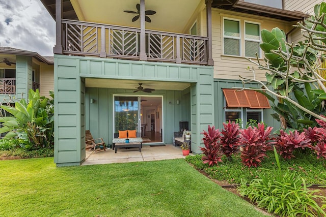 back of property featuring a patio, a balcony, ceiling fan, and a lawn