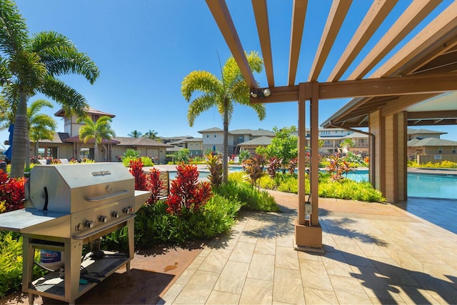 view of patio / terrace featuring area for grilling and a community pool