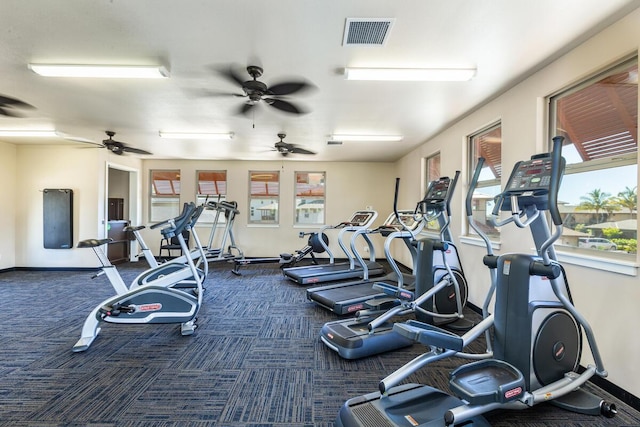 exercise room featuring dark carpet