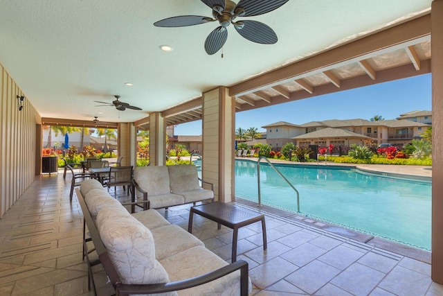 view of swimming pool featuring outdoor lounge area, a patio, and ceiling fan