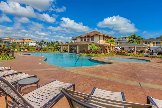 view of pool featuring a patio area and a hot tub