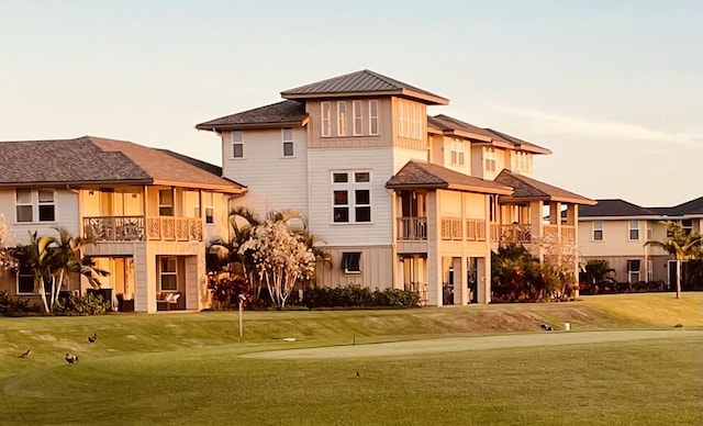 exterior space featuring a balcony and a yard