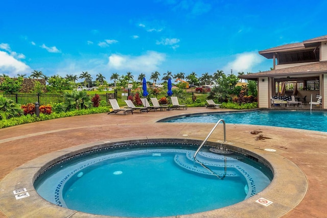 view of pool featuring a hot tub and a patio