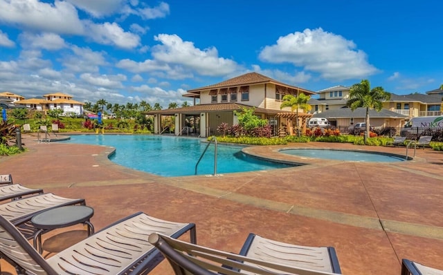 view of pool featuring a community hot tub and a patio area