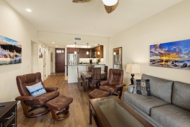 living room featuring hardwood / wood-style flooring and ceiling fan