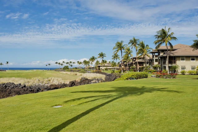 view of property's community featuring a water view and a yard