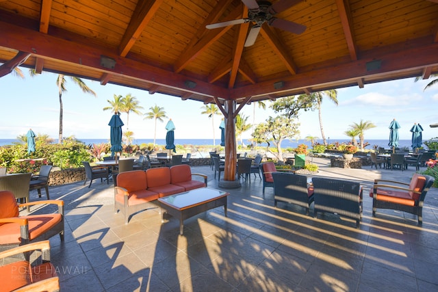 view of patio featuring a gazebo, a water view, an outdoor hangout area, and ceiling fan