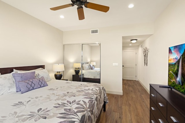 bedroom with wood-type flooring, a closet, and ceiling fan