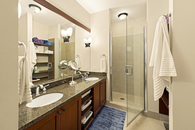 bathroom with tile patterned floors, a shower with shower door, and vanity