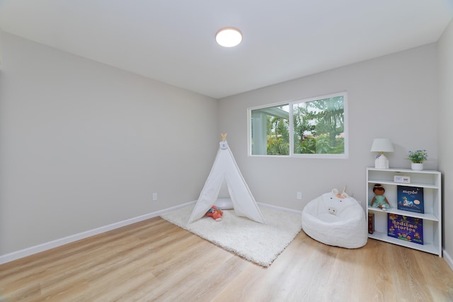 game room with light hardwood / wood-style floors