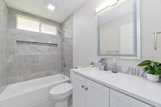 full bathroom featuring vanity, toilet, and tiled shower / bath