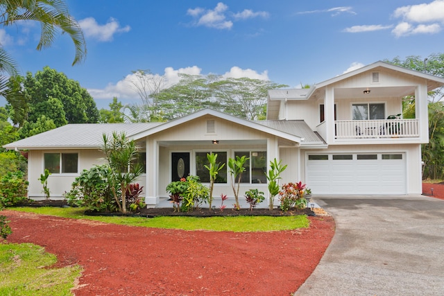 view of front of home featuring a garage and a balcony